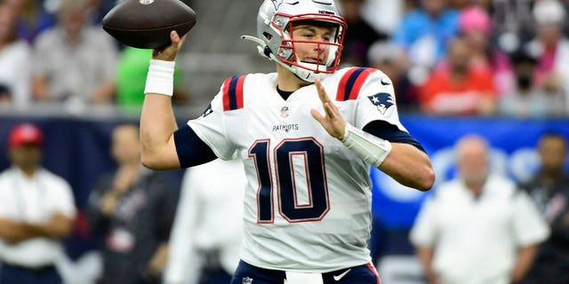 New England Patriots quarterback Mac Jones (10) throws a pass against the Houston Texans during the first half of an NFL football game Sunday, Oct. 10, 2021, in Houston.