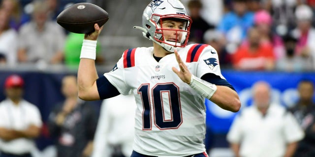 New England Patriots quarterback Mac Jones (10) throws a pass against the Houston Texans during the first half of an NFL football game Sunday, Oct. 10, 2021, in Houston.