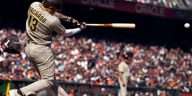 San Diego Padres' Manny Machado lines an RBI single against the Giants, Oct. 2, 2021, in San Francisco.