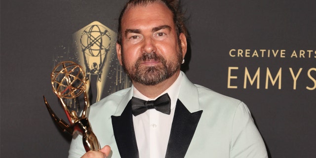 LOS ANGELES, CALIFORNIA - SEPTEMBER 11: Marc Pilcher poses with the award for Outstanding Period And/Or Character Hairstyling for "Bridgerton" at Microsoft Theater on September 11, 2021 in Los Angeles, California.