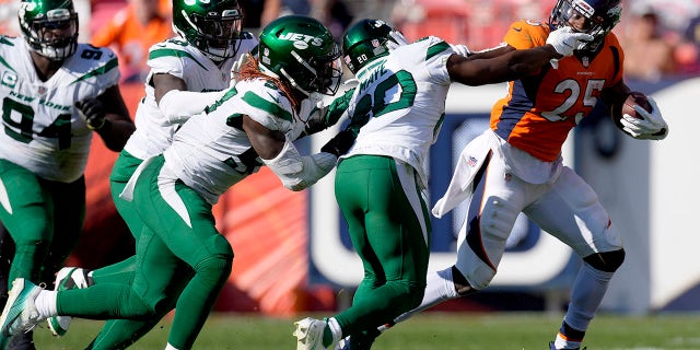 Denver Broncos running back Melvin Gordon (25) eludes the tackle of New York Jets free safety Marcus Maye (20) during the second half of an NFL football game, Sunday, Sept. 26, 2021, in Denver.