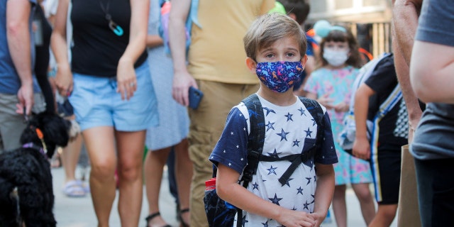 FILE PHOTO: A child wears a face mask on the first day of New York City schools, amid the coronavirus disease (COVID-19) pandemic in Brooklyn, New York, U.S. September 13, 2021. 