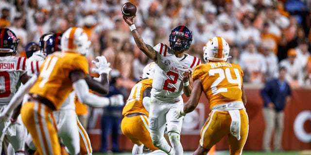 Mississippi quarterback Matt Corral (2) throws to a receiver as he's defended by Tennessee linebacker Aaron Beasley (24) during the second half of an NCAA college football game Saturday, Oct. 16, 2021, in Knoxville, Tenn. Mississippi won 31-26.