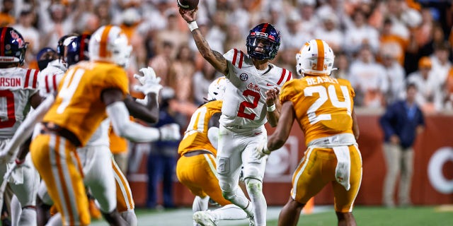 Mississippi quarterback Matt Corral (2) throws to a receiver as he's defended by Tennessee linebacker Aaron Beasley (24) during the second half of an NCAA college football game Saturday, Oct. 16, 2021, in Knoxville, Tenn. Mississippi won 31-26.