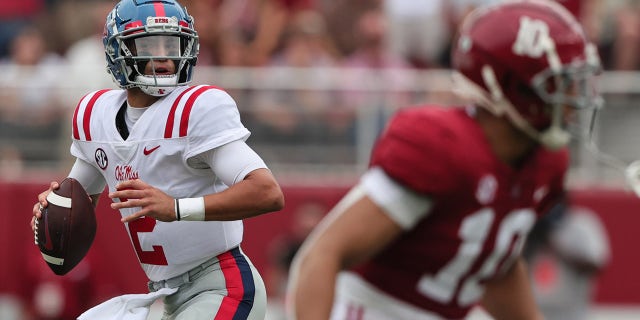 Oct 2, 2021; Tuscaloosa, Alabama, USA; Mississippi Rebels quarterback Matt Corral (2) rolls out to pass against the Alabama Crimson Tide during the first half of an NCAA college football game at Bryant-Denny Stadium.