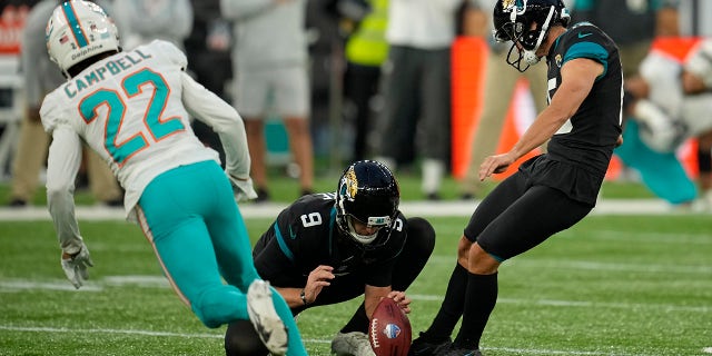 Jacksonville Jaguars kicker Matthew Wright (15), right, kicks a field goal to win the match during the second half of an NFL football game between the Miami Dolphins and the Jacksonville Jaguars at the Tottenham Hotspur stadium in London, England, Sunday, Oct. 17, 2021.