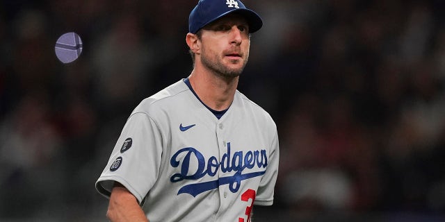 Los Angeles Dodgers starting pitcher Max Scherzer walks off the field after being relieved in the fifth inning in Game 2 of baseball's National League Championship Series against the Atlanta Braves Sunday, Oct. 17, 2021, in Atlanta.