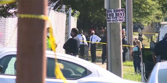 Authorities stand outside the East Lamar Carrier Annex facility in Memphis. Tenn., where two Postal Service employees were killed and a third died after taking their own life, the FBI said. 