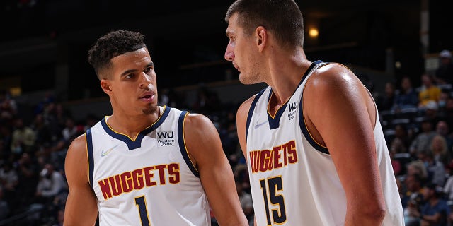 Michael Porter Jr. #1 of the Denver Nuggets talks to teammate Nikola Jokic #15 during a preseason game against the Minnesota Timberwolves on October, 2021 at the Ball Arena in Denver, Colorado.
