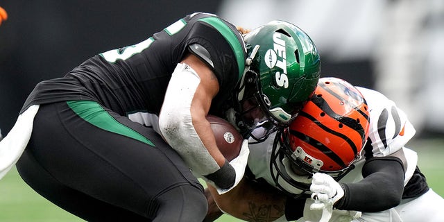 Cincinnati Bengals cornerback Mike Hilton (21) is penalized for a helmet-to-helmet hit on New York Jets running back Ty Johnson (25) in the fourth quarter during a Week 8 game Sunday, Oct. 31, 2021, at MetLife Stadium.