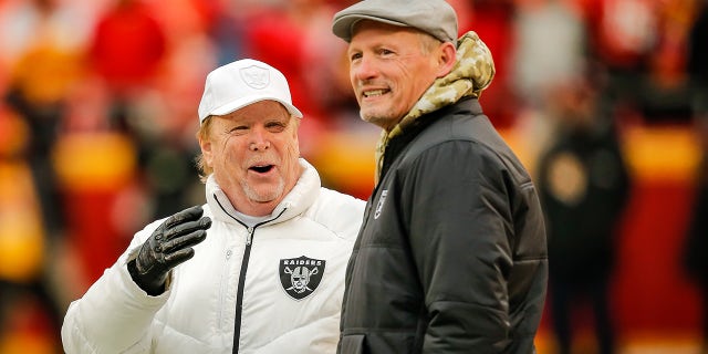 Oakland Raiders owner Mark Davis, left, watches his team during warmups with Oakland Raiders general manager Mike Mayock prior to the game against the Kansas City Chiefs at Arrowhead Stadium on December 1, 2019 in Kansas City, Missouri.