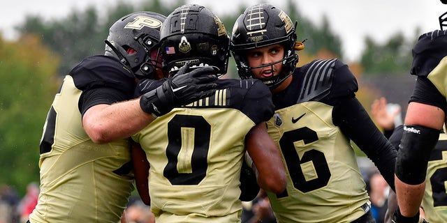 Purdue Boilermakers wide receiver Milton Wright (0) shares a moment with quarterback Aidan O'Connell (16) after a touchdown pass during the second quarter against the Minnesota Golden Gophers at Ross-Ade Stadium on October 2, 2021. 