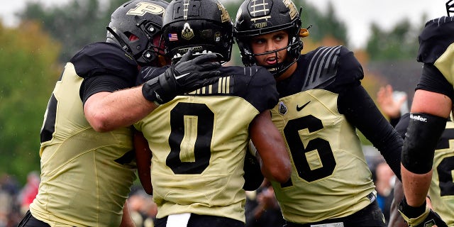 Purdue Boilermakers wide receiver Milton Wright (0) shares a moment with quarterback Aidan O'Connell (16) after a touchdown pass during the second quarter against the Minnesota Golden Gophers at Ross-Ade Stadium Oct 2, 2021.