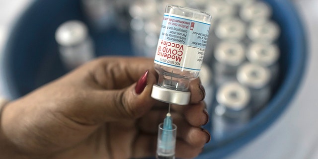 September 8, 2021: A nurse prepares the Moderna COVID-19 vaccine booster dose during a mass vaccination campaign in Dhaka, Bangladesh. 