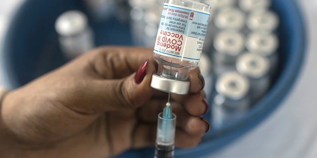 September 8, 2021: A nurse prepares the Moderna COVID-19 vaccine booster dose during a mass vaccination campaign in Dhaka, Bangladesh. 