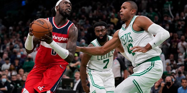 Washington Wizards center Montrezl Harrell, left, drives to the basket against Boston Celtics center Al Horford (42) during the second half of an NBA basketball game, Wednesday, Oct. 27, 2021, in Boston.