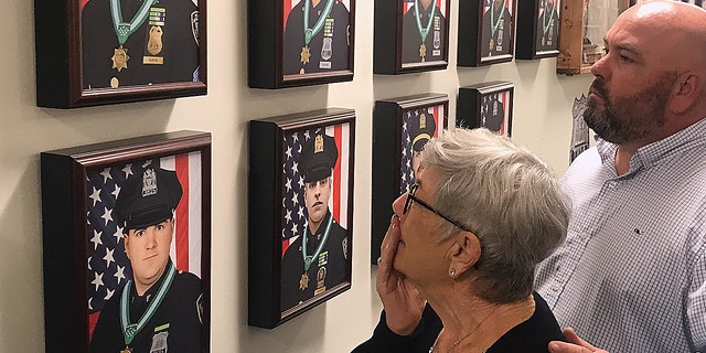 Families members attend the unveiling of the 9/11 memorial wall, "23 Remembered," situated inside the Police Benevolent Association of the City of New York's Manhattan headquarters. 