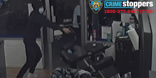 A second suspect then entered the barbershop and took his turn firing, video shows.