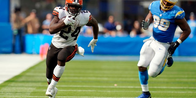 Cleveland Browns running back Nick Chubb (24) runs for a touchdown past Los Angeles Chargers defensive tackle Jerry Tillery (99) during the second half of an NFL football game Sunday, Oct. 10, 2021, in Inglewood, Calif.