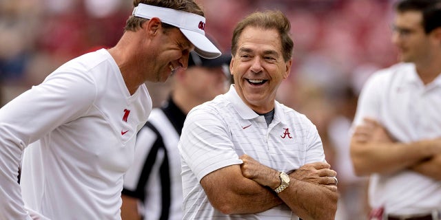 Mississippi head coach Lane Kiffin, left, and Alabama head coach Nick Saban share a laugh as they meet in the middle of the field before their game, Saturday, Oct. 2, 2021, in Tuscaloosa, Ala.