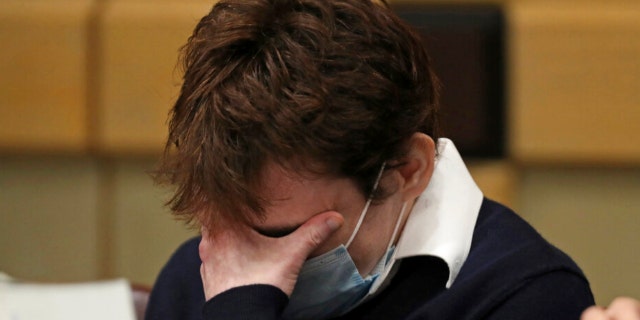 Parkland school shooter Nikolas Cruz holds his head in court during day two of jury selection in his trial at the Broward County Courthouse in Fort Lauderdale, Fla. on Wednesday, Oct. 6, 2021, on four criminal counts stemming from his alleged attack on a Broward jail guard in November 2018.