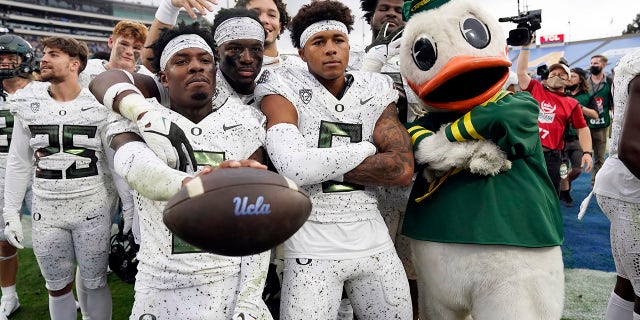 Oregon players and mascot celebrate a win over UCLA in an NCAA college football game Saturday, Oct. 23, 2021, in Pasadena, Calif.