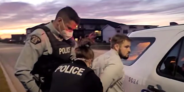 Pastor Tobias Tissen of Steinbach, Manitoba, is arrested on Oct. 18, 2021, after holding outdoor church services that exceeded the provincial limit of five people.