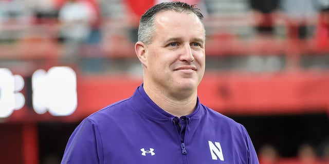 Head coach Pat Fitzgerald of the Northwestern Wildcats watches the team warm up before the game against the Nebraska Cornhuskers at Memorial Stadium on October 2, 2021 in Lincoln, Nebraska.