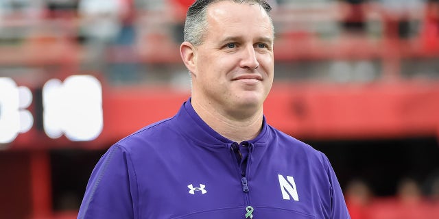 Head coach Pat Fitzgerald of the Northwestern Wildcats watches the team warm up before the game against the Nebraska Cornhuskers at Memorial Stadium on October 2, 2021 in Lincoln, Nebraska.