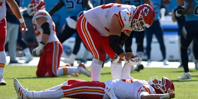 Kansas City Chiefs quarterback Patrick Mahomes is helped up by Mike Remmers (75) after Mahomes was hit in the second half of a game against the Tennessee Titans Sunday, Oct. 24, 2021, in Nashville, Tenn.