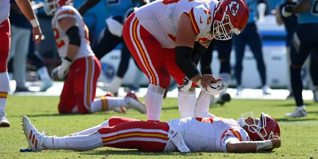 Kansas City Chiefs quarterback Patrick Mahomes is helped up by Mike Remmers (75) after Mahomes was hit in the second half of a game against the Tennessee Titans Sunday, Oct. 24, 2021, in Nashville, Tenn.