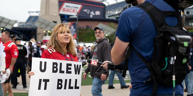 Laura Marci of Rhode Island talks with a WCVB local news reporter before a game between the New England Patriots and the Tampa Bay Buccaneers at Gillette Stadium.