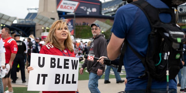 Laura Marci of Rhode Island talks with a WCVB local news reporter before a game between the New England Patriots and the Tampa Bay Buccaneers at Gillette Stadium.