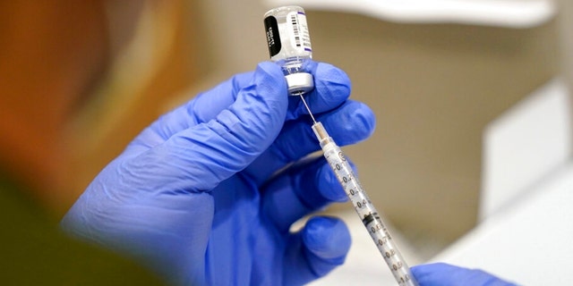 FILE - In this Oct. 5, 2021, file photo a healthcare worker fills a syringe with the Pfizer COVID-19 vaccine. (AP Photo/Lynne Sladky, File)