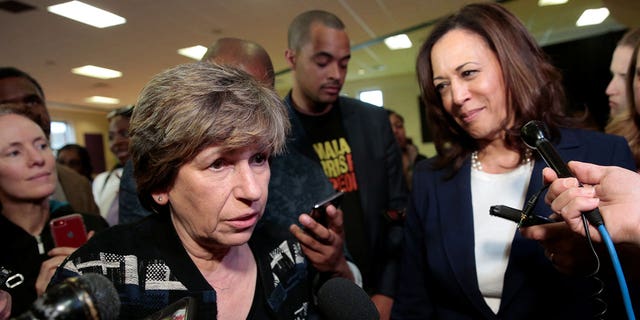 U.S. Senator Kamala Harris (R) listens to American Federation of Teachers president Randi Weingarten speak to the media after speaking to members of the AFT in Detroit, Michigan, U.S. May 6, 2019. REUTERS/Rebecca Cook