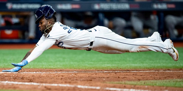 Randy Arozarena of the Tampa Bay Rays slips as he flies home in the seventh inning of Game 1 of the 2021 American League Division against the Boston Red Sox at Tropicana Field on October 7, 2021, in St. Petersburg , in Florida.