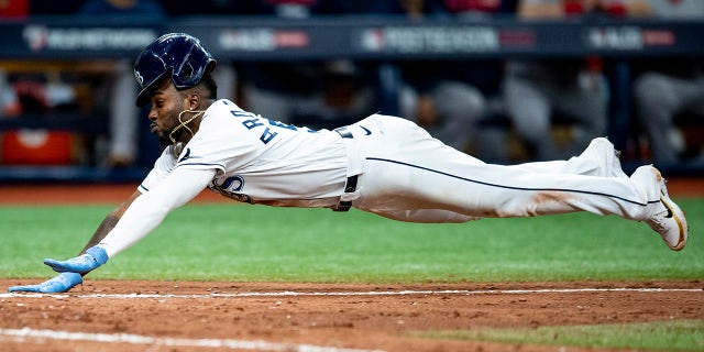 Randy Arozarena of the Tampa Bay Rays slides as he steals home during the seventh inning of game one of the 2021 American League Division Series against the Boston Red Sox at Tropicana Field on Oct. 7, 2021, in St.. Petersburg, Florida.