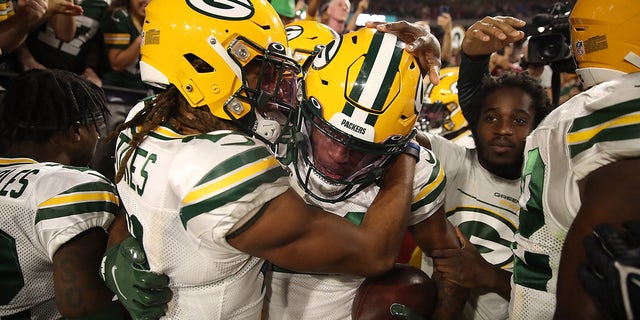 GLENDALE, ARIZONA - OCTOBER 28: Eric Stokes #21 of the Green Bay Packers congratulates Rasul Douglas #29 following an interception during the fourth quarter of a game against the Arizona Cardinals at State Farm Stadium on October 28, 2021 in Glendale, Arizona.