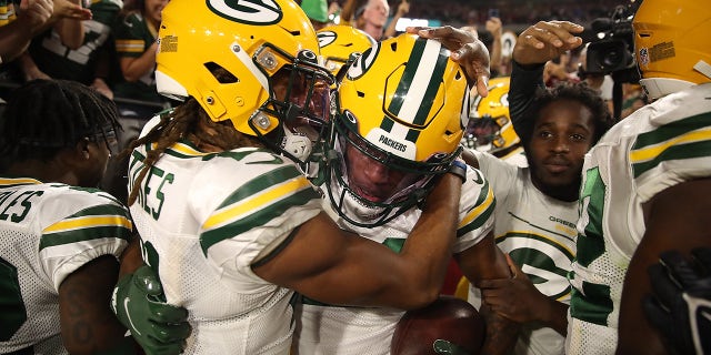 GLENDALE, ARIZONA - OCTOBER 28: Eric Stokes #21 of the Green Bay Packers congratulates Rasul Douglas #29 following an interception during the fourth quarter of a game against the Arizona Cardinals at State Farm Stadium on October 28, 2021 in Glendale, Arizona.