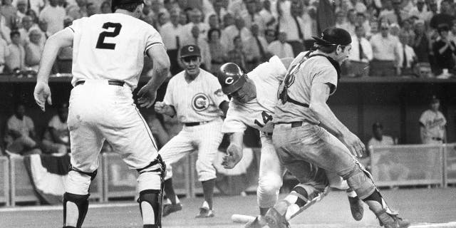 In this July 14, 1970, photo photo, National League's Pete Rose beats American League catcher Ray Fosse to score the winning race during the 12th inning of the baseball All-Star Game in Cincinnati. Looking at is third base coach Leo Durocher and on-deck batter Dick Dietz (2).