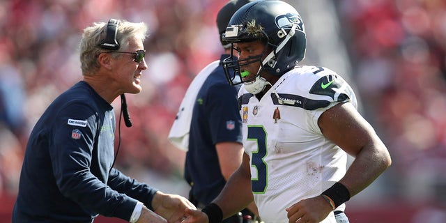 Seattle Seahawks quarterback Russell Wilson (3) is congratulated by head coach Pete Carroll after scoring against the San Francisco 49ers in the second half of an NFL football game in Santa Clara, California , Sunday October 3, 2021.