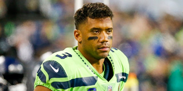 Seattle Seahawks quarterback Russell Wilson sits on the sidelines in the fourth quarter against the Los Angeles Rams at Lumen Field.