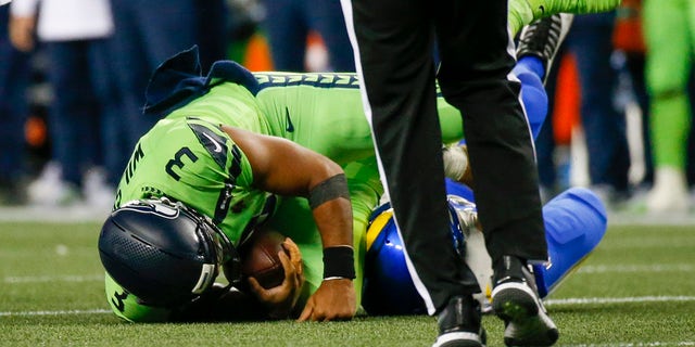 Seattle Seahawks quarterback Russell Wilson is sacked against the Los Angeles Rams in the third quarter at Lumen Field.