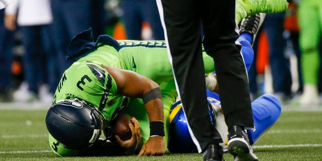 Seattle Seahawks quarterback Russell Wilson (3) is sacked against the Los Angeles Rams in the third quarter at Lumen Field.