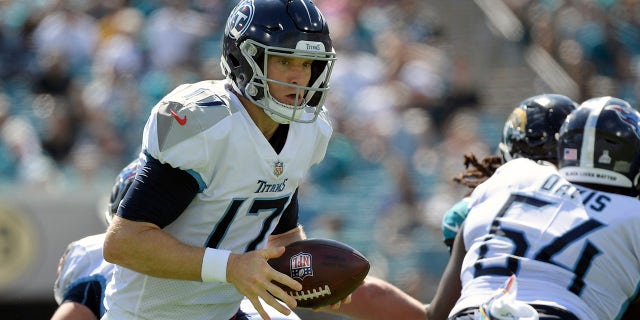 Tennessee Titans quarterback Ryan Tannehill (17) hands off the ball during the first half of an NFL football game against the Tennessee Titans, Sunday, Oct. 10, 2021, in Jacksonville, Florida.