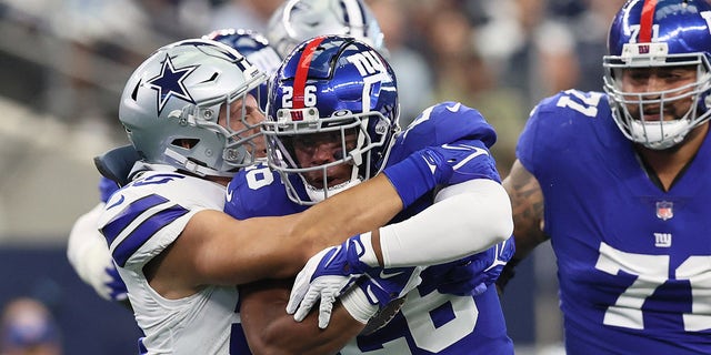 New York Giants running back Saquon Barkley (26) runs with the ball in the first inning against the Dallas Cowboys at AT&T Stadium.