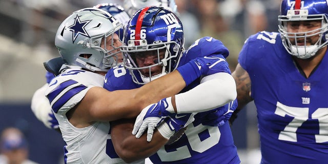 New York Giants running back Saquon Barkley (26) runs with the ball against the Dallas Cowboys at AT&T Stadium.