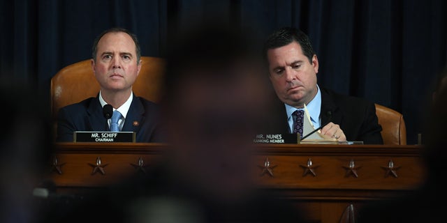 House Intelligence Committee chair Adam Schiff, D-Calif., and Rep. Devin Nunes, R. Calif., are seen as David A. Holmes, Department of State political counselor for the United States Embassy in Kyiv, Ukraine, and Fiona Hill, former National Security Council senior director for Europe and Russia, appear before the House Intelligence Committee during an impeachment inquiry hearing at the Longworth House Office Building on Nov. 21, 2019, in Washington, D.C. (Pool Photo by Matt McClain/The Washington Post via Getty Images)