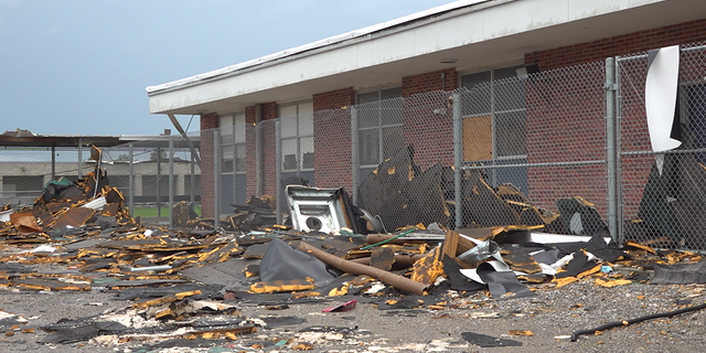 The school yard at South Lafourche High School is filled with debris from Hurricane Ida. 