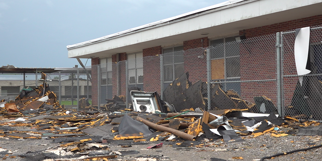 The school yard at South Lafourche High School is filled with debris from Hurricane Ida.